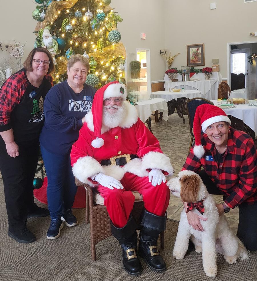 The Elder Orphan Care staff including Aji our therapy dog with Santa Danny