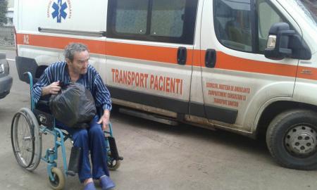 A man who is homeless is brought by ambulance to one of Viorel Pasca's elder care homes in Romania