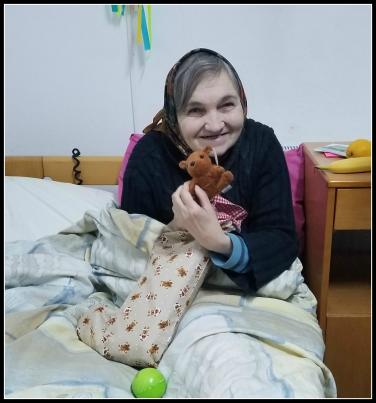 Elder Orphan Care friend in Romania loves the gifts in her Christmas Stocking of Joy