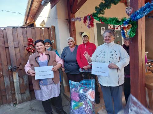 Elder Orphan Care partners hold signs expressing their gratitude for Elder Orphan Care