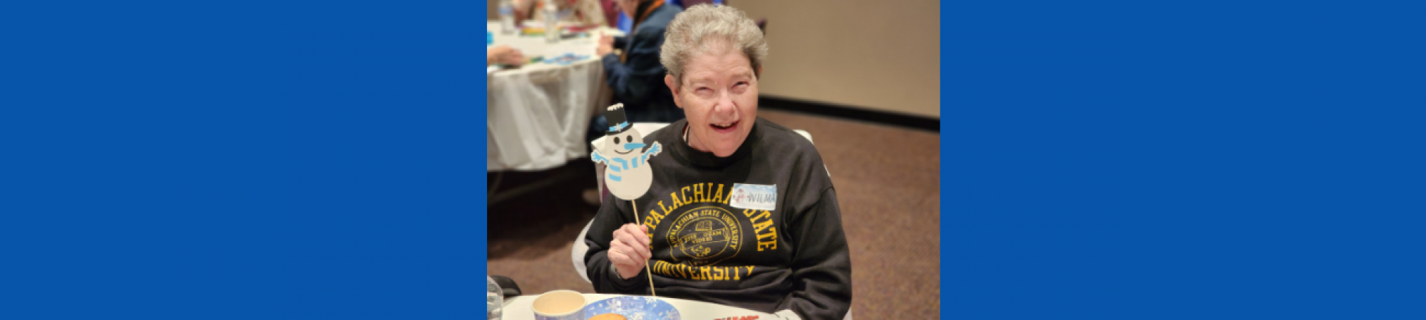 Elder Orphan Care friend enjoys our Winter Wonderland Celebration