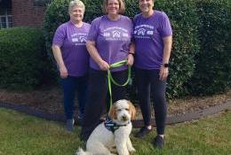 Aji, Elder Orphan Care's therapy dog, with the EOC staff