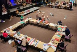 Volunteers gather to pack Christmas bags and wrap gifts for Elder Orphan Care friends
